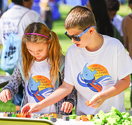 Image of girl and boy participating in Festival activity.