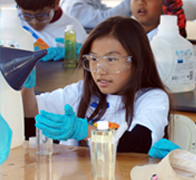 Image of girl performing an experiment.