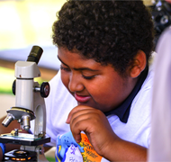 Image of boy working with a microscope.