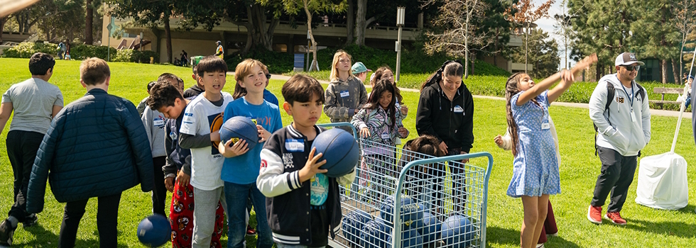 Children shooting basketballs